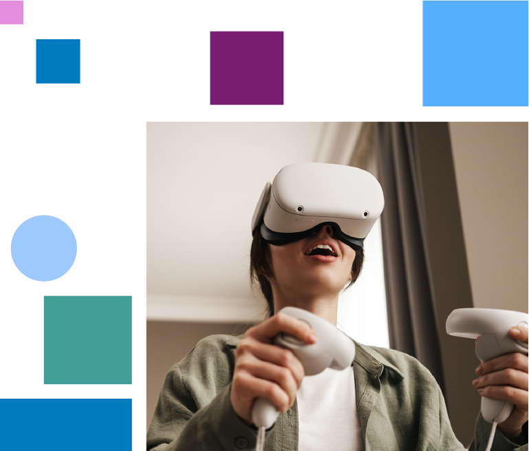 Woman sitting on a beige sofa in a living room, wearing VR glasses and holding game controllers in both hands