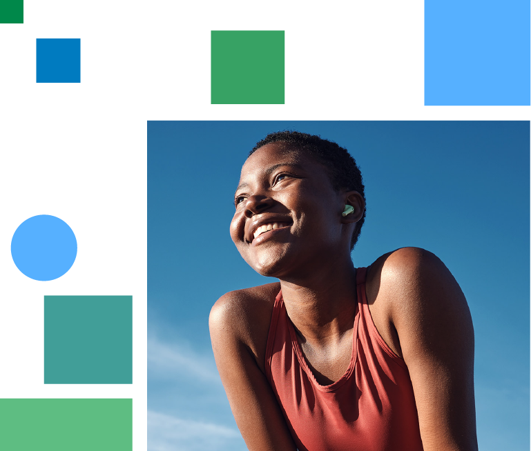 smiling woman doing sports in front of a blue sky