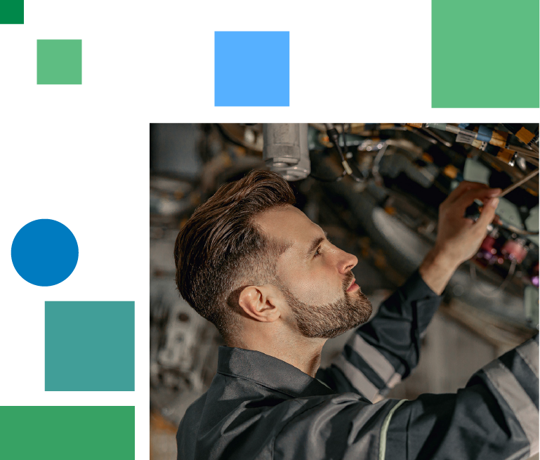 younger mechanic in work clothes checks mechanical airplane components 